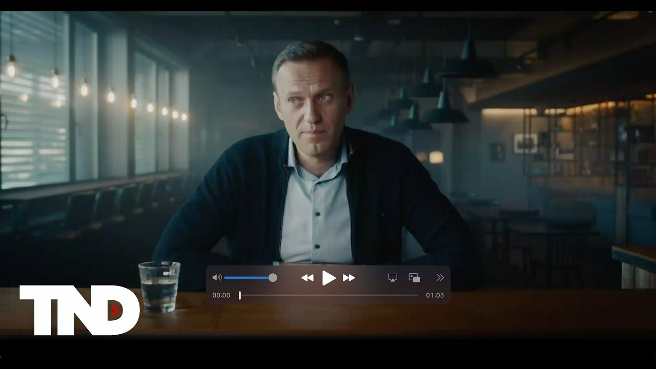 Photo of Alexei Navalny sitting in a Bar.